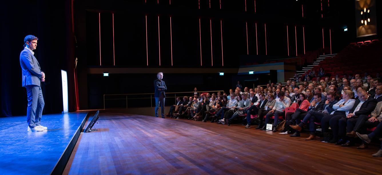 speaker on stage in front of an audience
